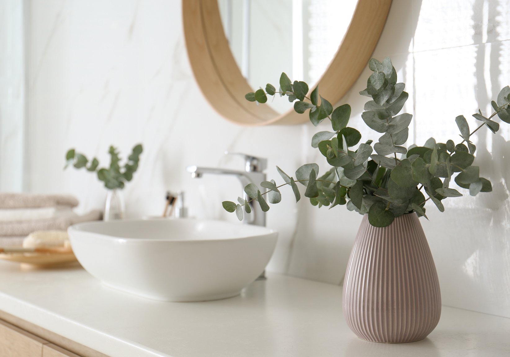 Fresh Eucalyptus Branches on Countertop in Bathroom